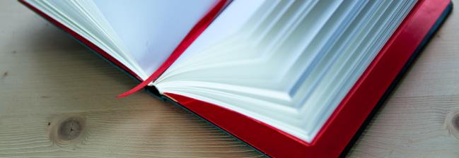 a blank notebook with a red cover